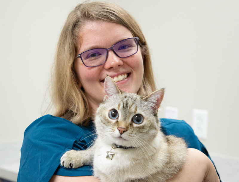 Our staff holding a cat in her arms.